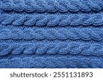 handmade blue knitted fabric with cable braids texture