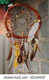 Handmade Brown Dream Catcher At Wall In Background