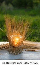 Handmade Candle Holder And Wheat Ears On Wooden Table, Natural Summer Background. Symbol Of Lammas, Lughnasadh Pagan Holiday. Celtic Wiccan Sabbath. Witchcraft Ritual