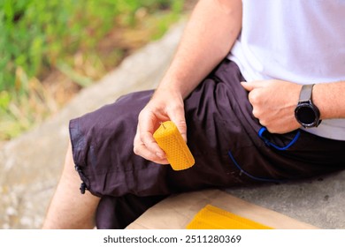 Handmade candle made of natural beeswax in the shape of a heart in the hands of a man. - Powered by Shutterstock