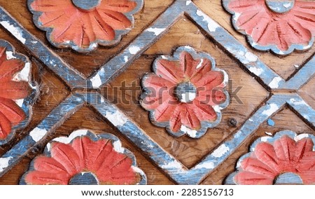 handmade carved flowers on wooden background
