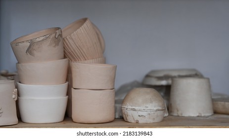 Handmade Ceramic Crockery On Wooden Shelf In Creative Studio