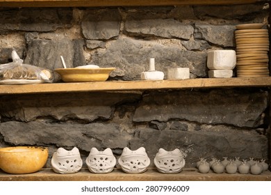 Handmade Ceramic Cups Drying on Shelves Before Kiln Firing in Pottery Workshop