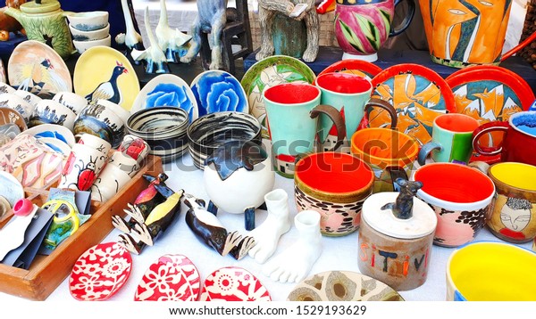  handmade ceramics\
folk crafts city market place  street bazaar  outdoor  glass cup\
plate colorful 