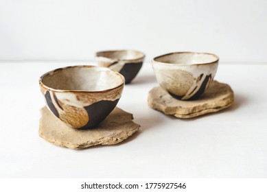 Handmade ceramics in the style of wabi sabi. Brown clay bowls with an abstract pattern.