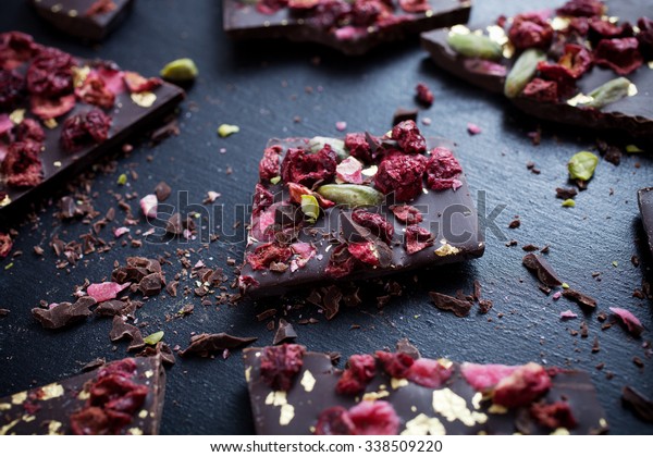 Handmade chocolate with berries, pistachios and\
edible gold