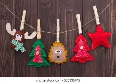 Handmade Christmas Toys Hanging On Clothespin On Wooden Background