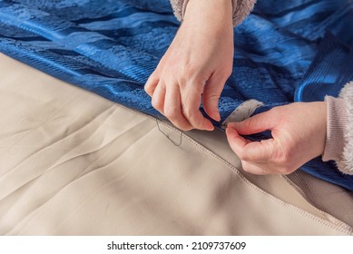 Handmade Clothes. The Master Of Tailoring Stitches The Fabric. In The Hands Of A Needle And Thread. The Dressmaker At Work. A Woman Stitches The Material. Handmade Sewing.