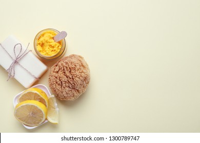 Handmade Cosmetics, Organic Fruit  Mask In Glass Jar, Soap, Slices Of Lemon And Sea Sponge On Yellow Background, Copy Space