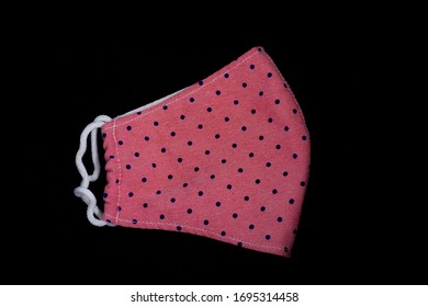 Handmade Cotton Fabric Mask With Polka Dot Patten For Protection Of Air Pollutants And Corona Virus (Covid 19) Isolated On Black Background