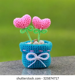 Handmade Crochet Heart On Green Background.