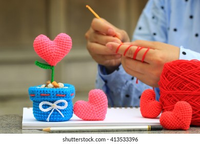 Handmade Crochet Heart And Woman With Her Crocheting