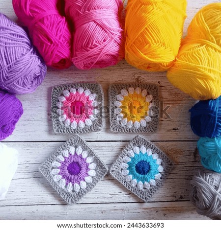 Handmade crocheted granny squares are the background. for background texture images and illustrations