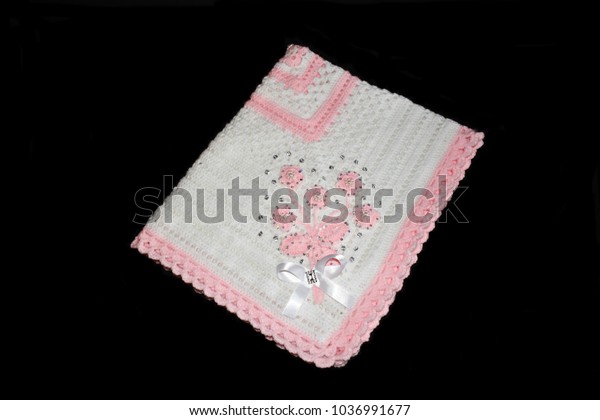 pink and white baby blanket