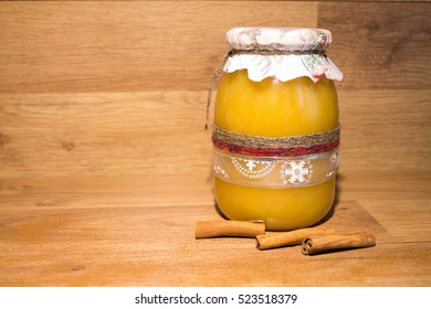 Handmade decorated jar with organic homemade honey with cinnamon sticks and powder on the wooden background. - Shutterstock ID 523518379