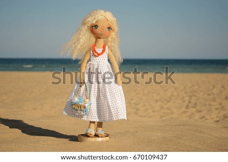 Handmade doll on the beach