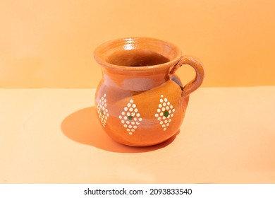 Handmade Earthenware Mug On Orange Background