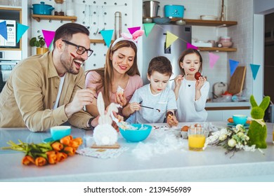 Handmade easter eggs painted by the whole family. Happy easter! family mother, father and children having fun paint and decorate eggs for holiday. Happy family painting Easter eggs - Powered by Shutterstock