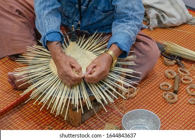 Handmade handcraft wicker rattan and bamboo traditional Thai wooden hat weaving process by artisan craftsman elderly