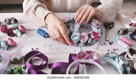 Handmade headbands making, home workshop. Unrecognizable woman artisan decorating hair hoop with flowers and ribbons. Art, handicraft, creative concept