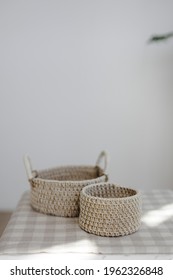 Handmade Home Decor Made From Organic Jute Fiber. Two Wicker Jute Baskets Are Arranged On A Checkered Linen Napkin. The Concept Of Home Decor And Comfort In The Eco Style.