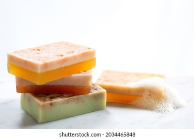 Handmade Kombucha natural soap, stack of soap bars with foam on white background, soap bubbles