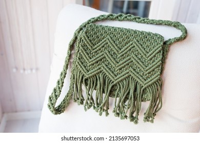 Handmade macrame bag dark green color. ECO friendly natural macrame cotton cross-body bag. Hobby knitting handmade macrame. Modern summer concept. 