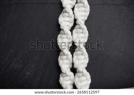 Handmade macrame on space background.