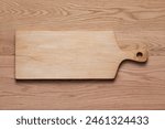 Handmade maple wood cutting boards sit on an oak tabletop. Handmade wooden cutting board.