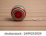 Handmade Mexican wooden toy.
yoyo made of colored wood on a wooden table