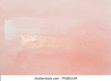 Handmade modern subtle pink abstract painted background texture with shiny metallic golden brush stroke