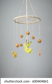 Handmade Multicolor Baby Crib Mobile With Rattan Balls Close Up On Turquoise Background