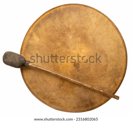handmade, native American style, shaman frame drum covered by goat skin with a beater isolated on white