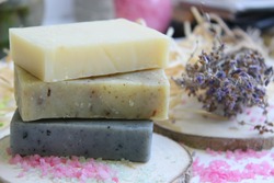 Handmade Natural Soap On Wooden Background. Spa Natural Treatments. Organic Natural Soap With Body Brush, Oil Bottle And Cotton Towel, Spa And Wellness Products.