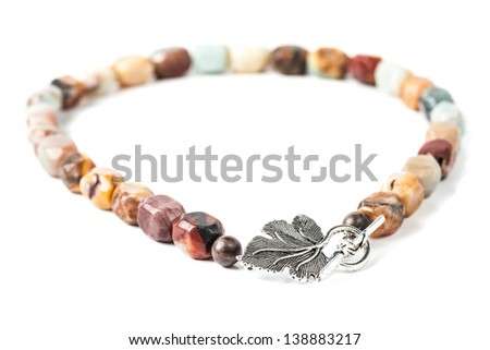 Handmade necklace with brown gemstone beads on white background
