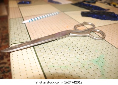 handmade needlework with collar and scissors on table