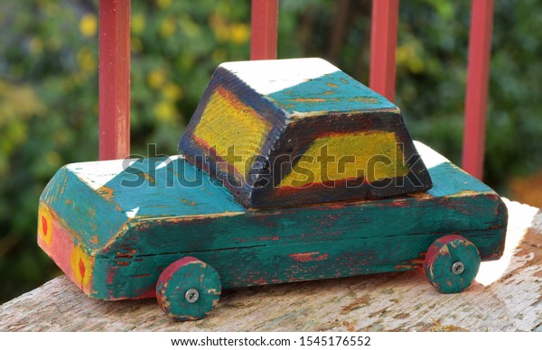 handmade old wooden\
car in wooden\
background