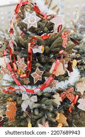 Handmade Painted Plastic And Paper Christmas Decorations On Christmas Tree Outdoors. DIY For Children. Environment, Recycle, Reuse, Upcycling, Zero Waste Concept. Selective Focus, No Snow Background