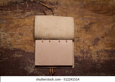 Handmade Paper Diary Notebook In  Leather Cover Over Old Vintage Wooden Table Surface Background