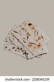 Handmade paper with rough texture and embedded pressed dried flowers, recycled paper. Floral decor to print on the wall. Botanical poster. Modern art. Vertical shot.