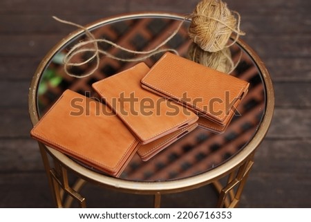 Handmade products made of genuine yellow and red leather. Leather passport cover, leather wallet. Leather goods for men. Top view
