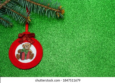 Handmade red Christmas tree toy made felt in the form ball and cross  stitch teddy bear
