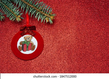 Handmade red Christmas tree toy made felt in the form ball and cross  stitch teddy bear