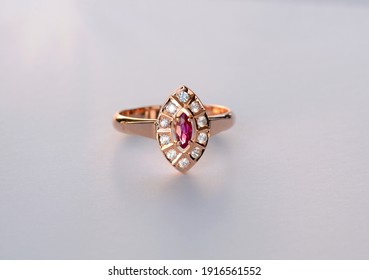 Handmade Rose 585 Gold Womens Ring With Natural Gemstones. Marquis Shaped Red Untreated, Unheated Ruby And Round White Sapphires Around. Isolated Jewelry, Ring On White Background.