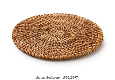 Handmade round woven placemat placed on a white background.