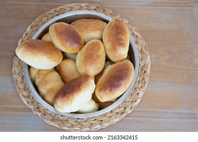 Handmade Russian Stile Delicious Warm Pies Are Cooked In The Oven Are Preparing For Weekend Breakfast Waiting At The Wooden Structure Cruft Table In The Farm Kitchen. No Diet Day.