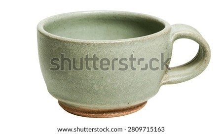 Handmade rustic sage green ceramic tea cup with textured clay finish