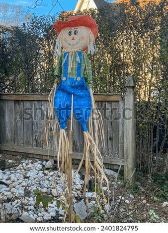 Handmade scarecrow in the yard of a country house in winter. Merry Christmas, Thanksgiving and New Year holiday concept