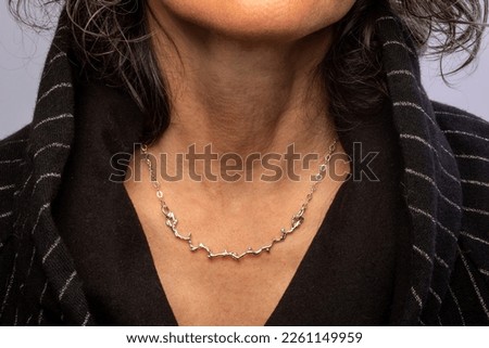 Handmade silver and glass women's necklaces on model's neck Detail Macro shot different perspective angles fashion trend women's jewelry abstract pastel natural background images buying now. 