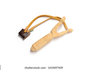 Handmade slingshot catapult. Y-shaped wooden stick with elastic tied between two top parts. Slingshot or Catapult is device for shooting small stones.